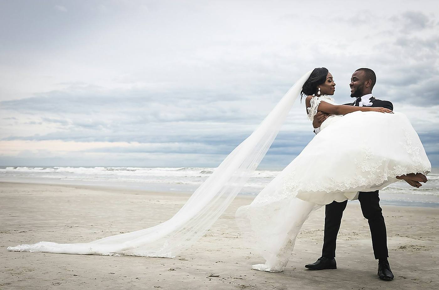 Beach wedding couple embracing at sunset in Zanzibar