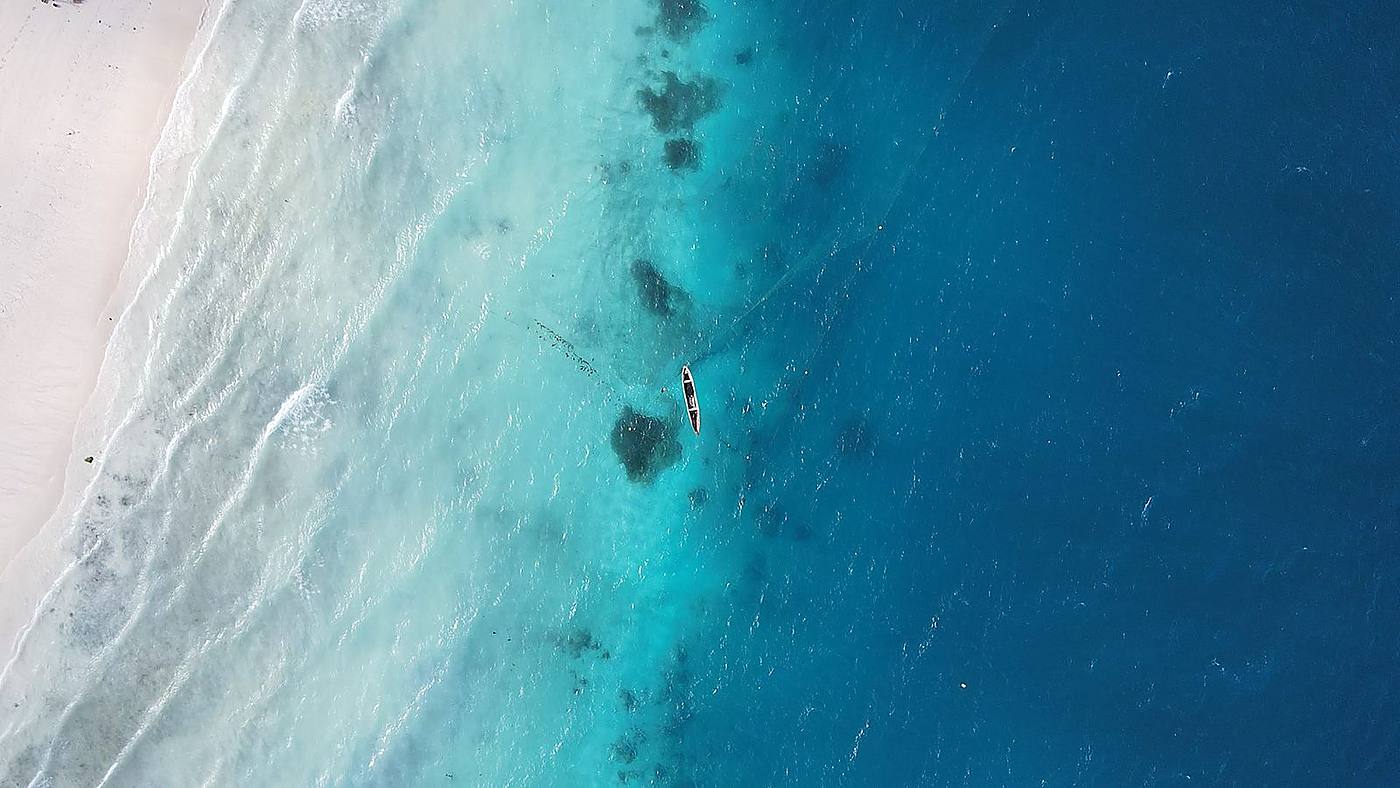 Aerial drone view of a turquoise Zanzibar beach